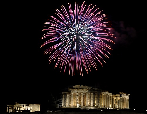 Fireworks burst over the ancient temple