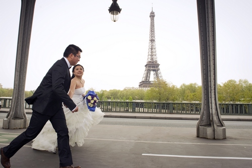 A bride and her husband walk in front of